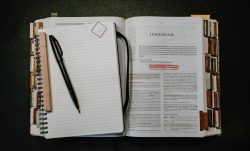 Open book and notebook with pen and ruler